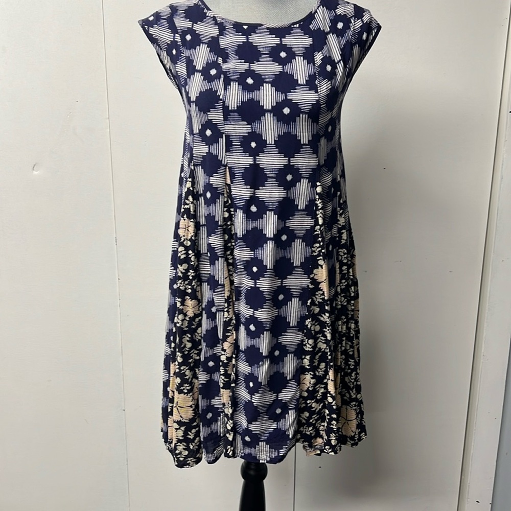 Cap sleeve dress in two fabrics with corset style tie down the back.